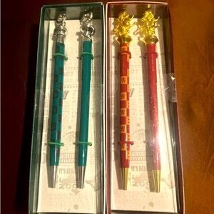 Two Harry Potter sets of pens and pencils from Gryffindor and Slytherin